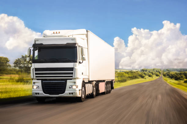 istock White truck moving on a road 1282845573