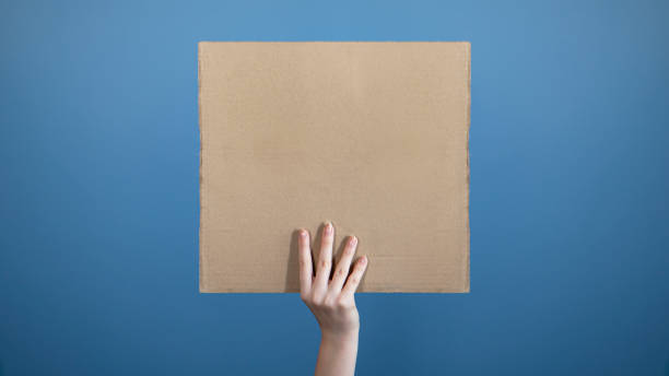 men standing with empty cardboard. hands holding big banner sheet of cardboard - protest political rally crowd politics imagens e fotografias de stock