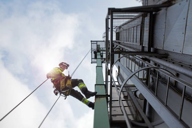 istock Epic view on Manual rope access technician - worker abseil from tower - antenna in sun beams 1282848210