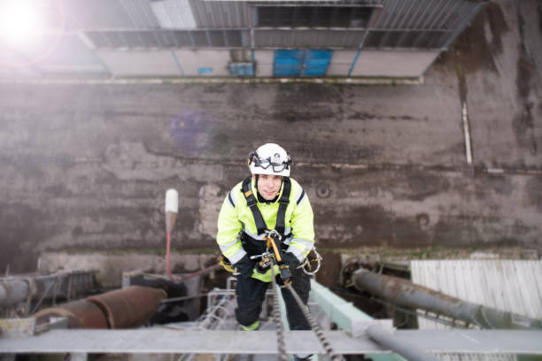 istock View from above on manual rope access technician - worker abseil from tower - antenna and looking in to the camera 1282848213