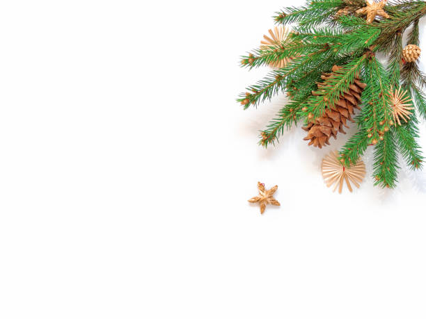 istock Natural coniferous branches and pine cones are decorated with straw decorations and bathed in the sun. Christmas, New Year concept. Flat lay. Top view. Copy space. 1282848799