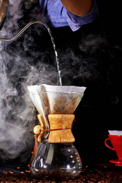 istock Drip coffee, barista pouring water on coffee ground with filter. 1282849026