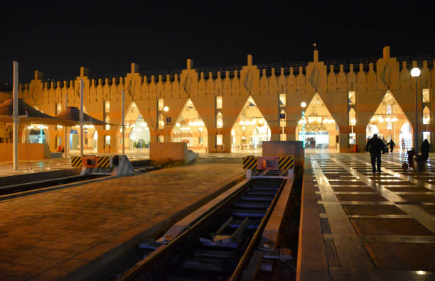 Larissa: A suburban train is approaching the passengers platform at the Larissa train station in the evening.