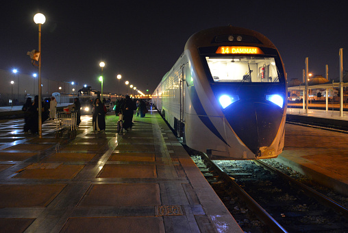 Dammam, Eastern Province, Saudi Arabia: night view along the central platform at Dammam railway station, fast train from Riyadh arrived on the platform - built in Spain by CAF, Construcciones y Auxiliar de Ferrocarriles - western terminus of the Dammam–Riyadh Line - Saudi Railways Organization (SRO), a state-owned Saudi railway company.