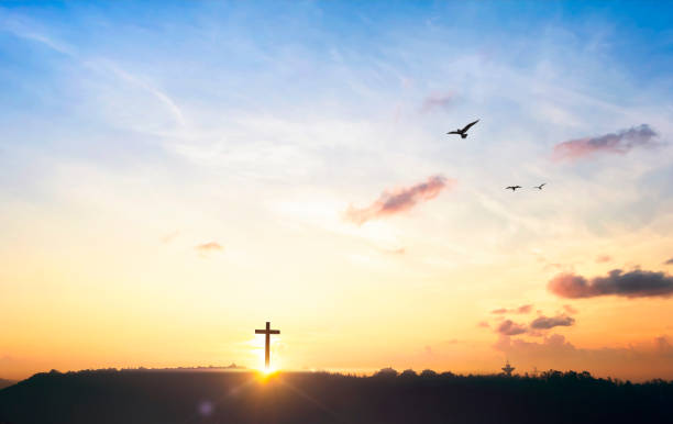 istock Religious cross concept: Silhouette cross on mountain at sunset background 1282850447