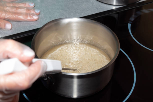 istock Boiling sugar syrup in a saucepan, the pastry chef measures its temperature. The process of making dessert. 1282851115