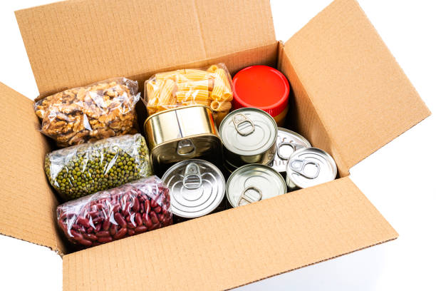 cardboard box filled with non-perishable foods. high angle view. - non perishable imagens e fotografias de stock