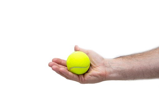 The man's hand is holding a tennis ball. An isolated item on a white background. Copy space