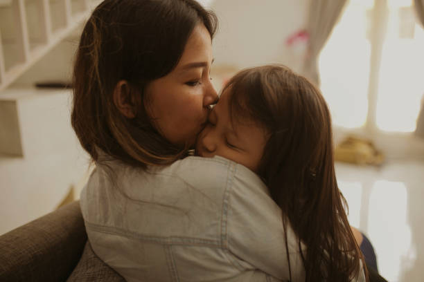 istock kid sleep on her mother arms 1282855181