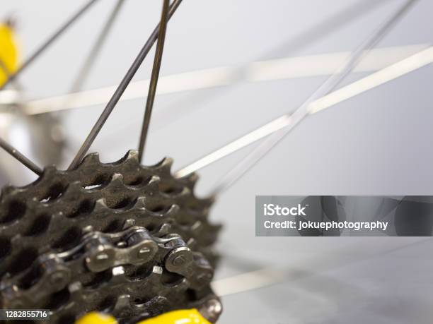 Details Of A Bicycle Chain And Sprockets With Blurry Spokes At The Back Wheel Of A Race Bike Stock Photo - Download Image Now