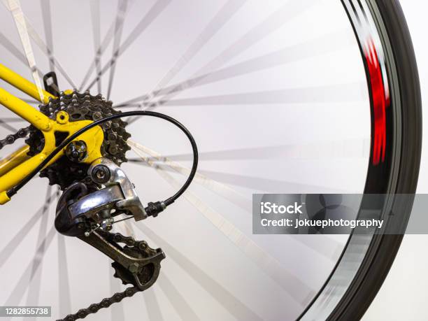 Details Of A Rear Detailleur At The Rear Wheel Of A Race Bike With Spokes In Motion Blur Stock Photo - Download Image Now