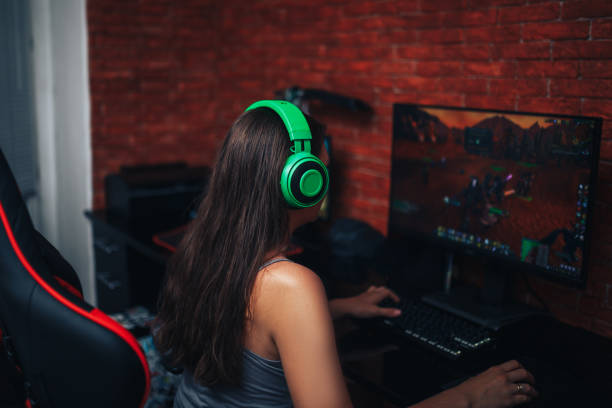 istock young girl playing game on computer, banner 1282856753