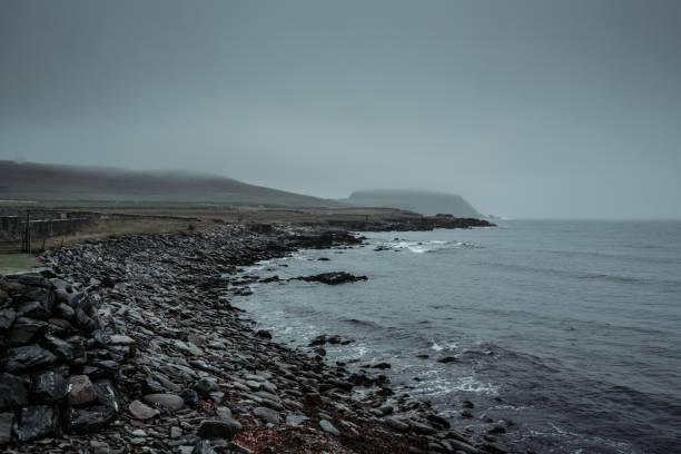 A pebble beach near Sumburgh Head A pebble beach near Sumburgh Head, the southern tip of mainland Shetland, rainy foggy autumn day. scottish highlands photos stock pictures, royalty-free photos & images