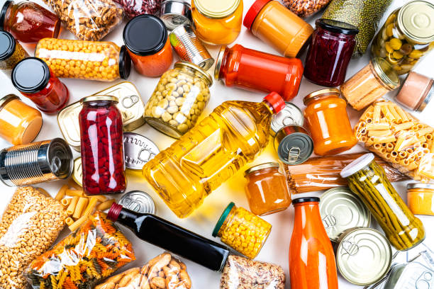 istock Non-perishable food background: canned goods, conserves, sauces and oils. Overhead view. 1282857839