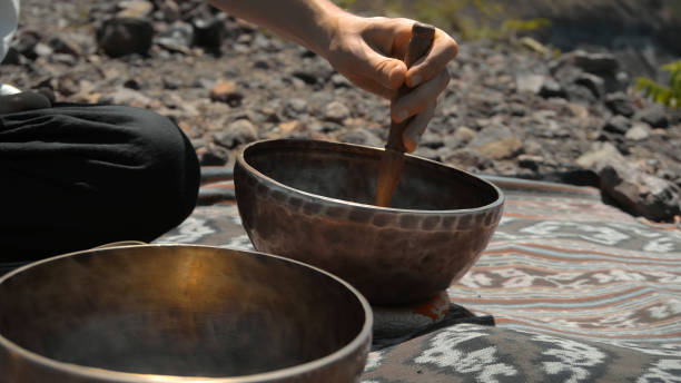 istock Asian guy playing Tibetan singing copper cups on a viewing mountain 1282859300