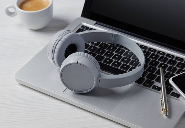 istock Headphones and laptop on desk 1282859316