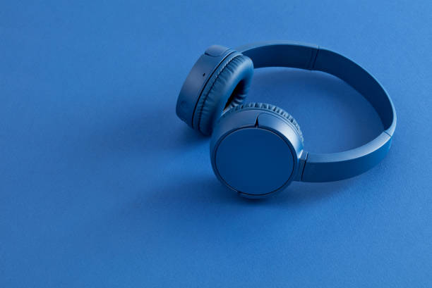 istock Blue headphones on blue background 1282859319