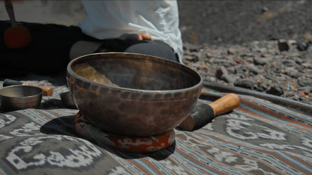 istock Asian guy playing Tibetan singing copper cups on a viewing mountain 1282859389