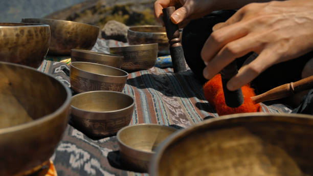 istock Asian guy playing Tibetan singing copper cups on a viewing mountain 1282859486