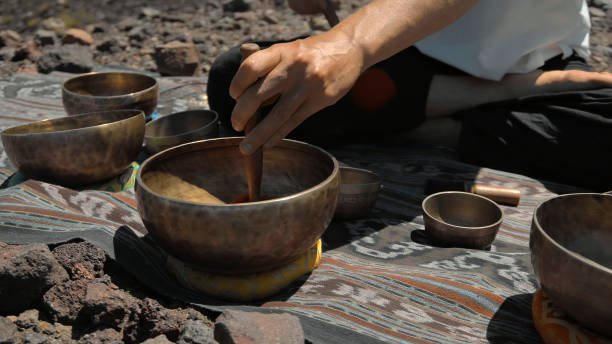 istock Asian guy playing Tibetan singing copper cups on a viewing mountain 1282859613