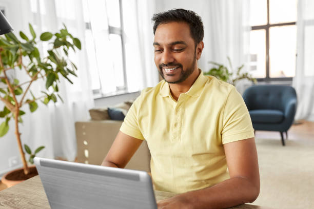 istock indian man with laptop working at home office 1282859634