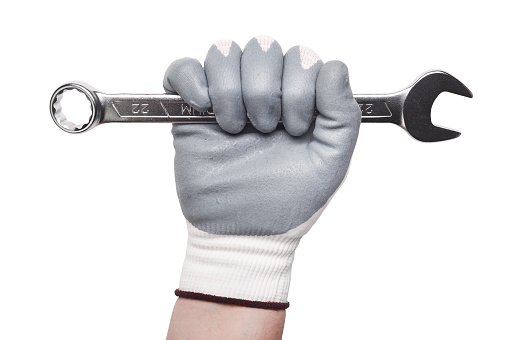 Worker hand holding spanner isolated on white background - clipping paths.Worker hand in a glove.
