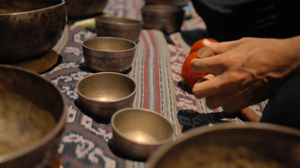 istock Asian guy playing Tibetan singing copper cups on a viewing mountain 1282860878