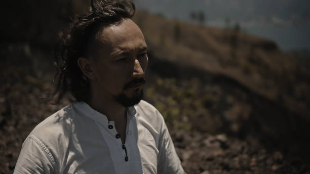 istock Asian guy playing Tibetan singing copper cups on a viewing mountain 1282861286