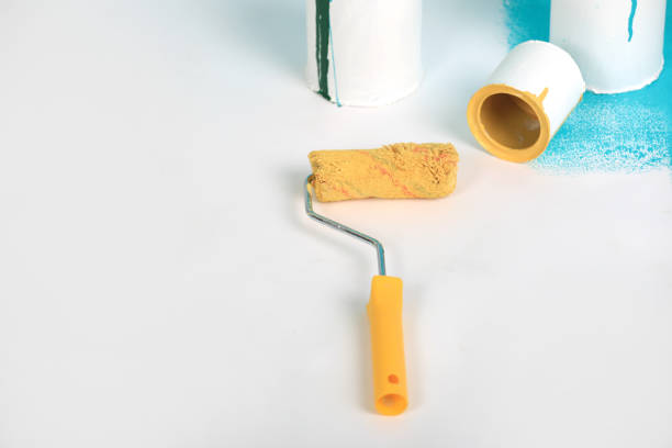istock Instruments for renovation apartment room isolated on white and blue background. accessories for gluing, painting tools. Colorful paint cans. Concept of repair home. Copy space for advertisement 1282861351