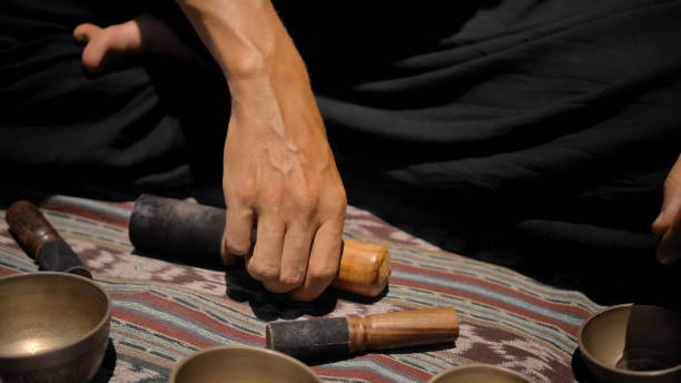 istock Asian guy playing Tibetan singing copper cups on a viewing mountain 1282861432