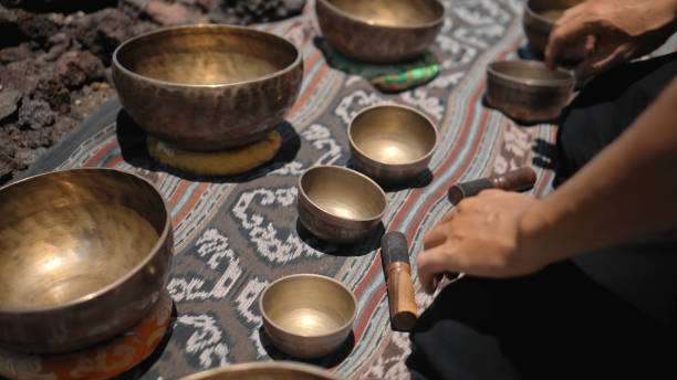 istock Asian guy playing Tibetan singing copper cups on a viewing mountain 1282862336