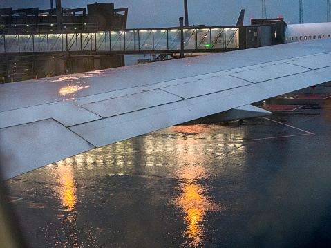 rain drops on a window view from airplane at the airport rainy day in Iceland