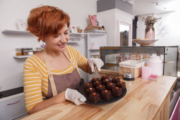 istock Female confectioner working at her cafe 1282864197