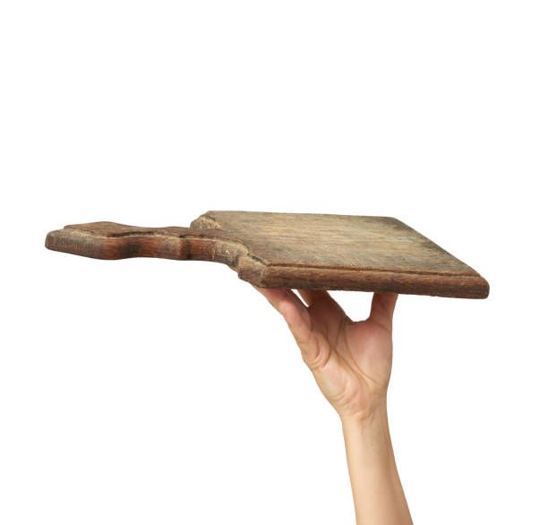 istock woman holding blank brown rectangular wooden board in hand 1282867888