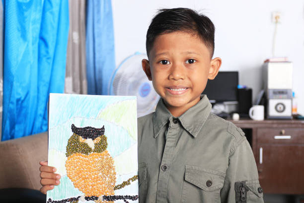 istock An elementary student showing the results of a craft, an assignment from school. 1282868471
