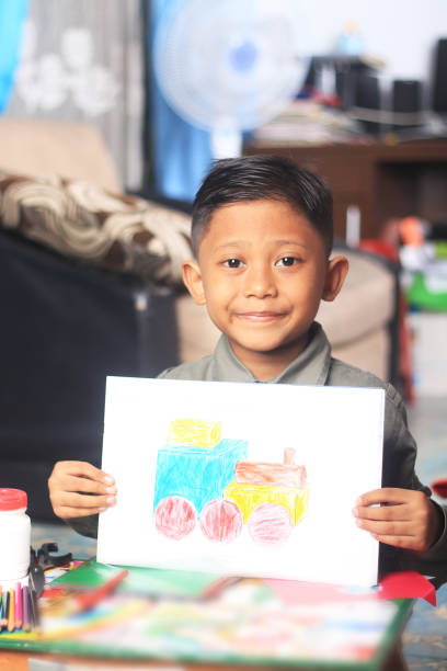 istock An elementary student showing the results of a craft, an assignment from school. 1282870311