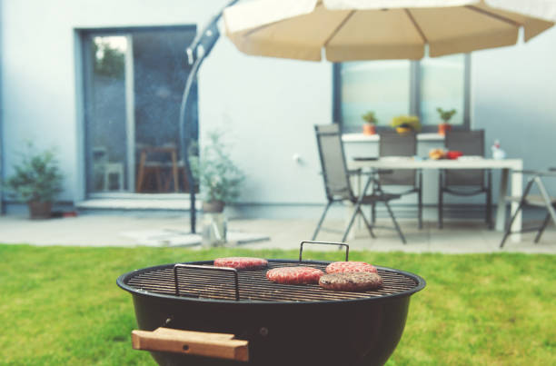 Close up of a grilling beef burger at cozy terrace in summer stock photo