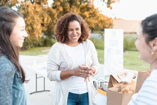istock Three female friends chat during break in food drive 1282871059