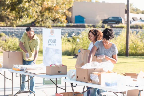 istock Multi-ethnic group sorts donated food into bags 1282871064
