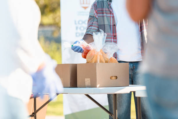 istock Unrecognizable people sort food at food drive 1282871161