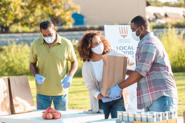istock Adults cheerfully work together at local food drive 1282871165