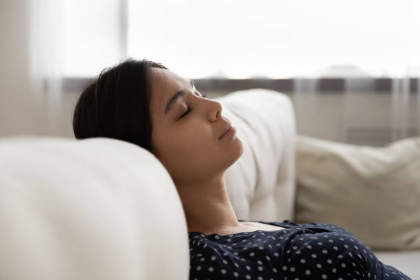 istock Calm ethnic woman fall asleep on cozy couch 1282871846