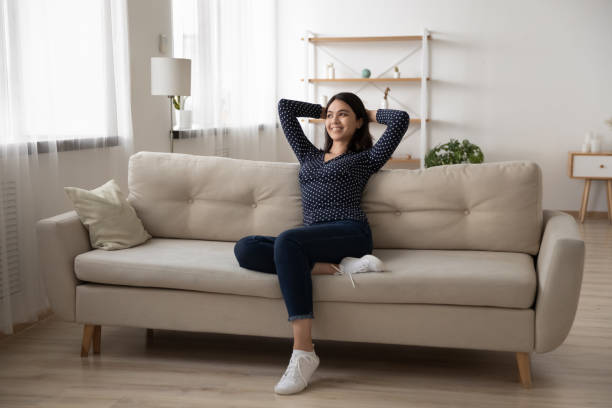 istock Happy asian woman relax on couch dreaming 1282871848