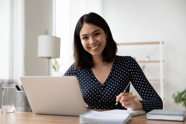 istock Portrait of smiling asian girl study online on computer 1282871872