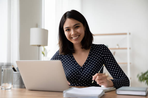 portrait of smiling asian girl study online on computer - business seminar writing women imagens e fotografias de stock