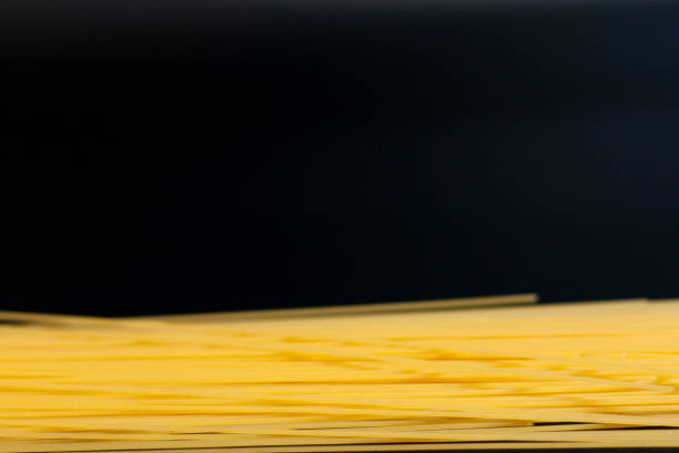 Macaroni is thin at the bottom of the screen on a dark background.
