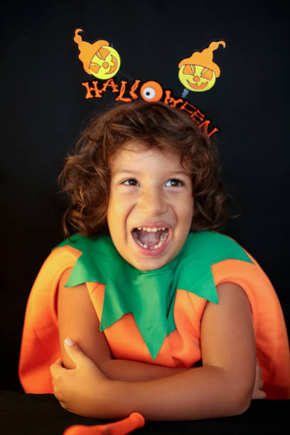 istock Cute kid in halloween costume scaring pose. 1282874446
