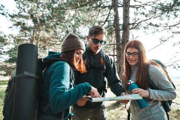 istock Friends on a hike reading the trails map 1282874471