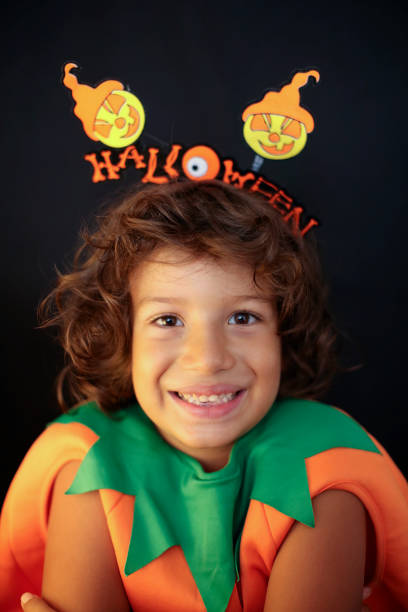 istock Cute kid in halloween costume scaring pose. 1282874958