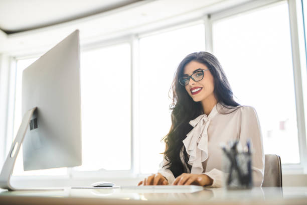 istock Fashion young woman working on computer in her office 1282875186